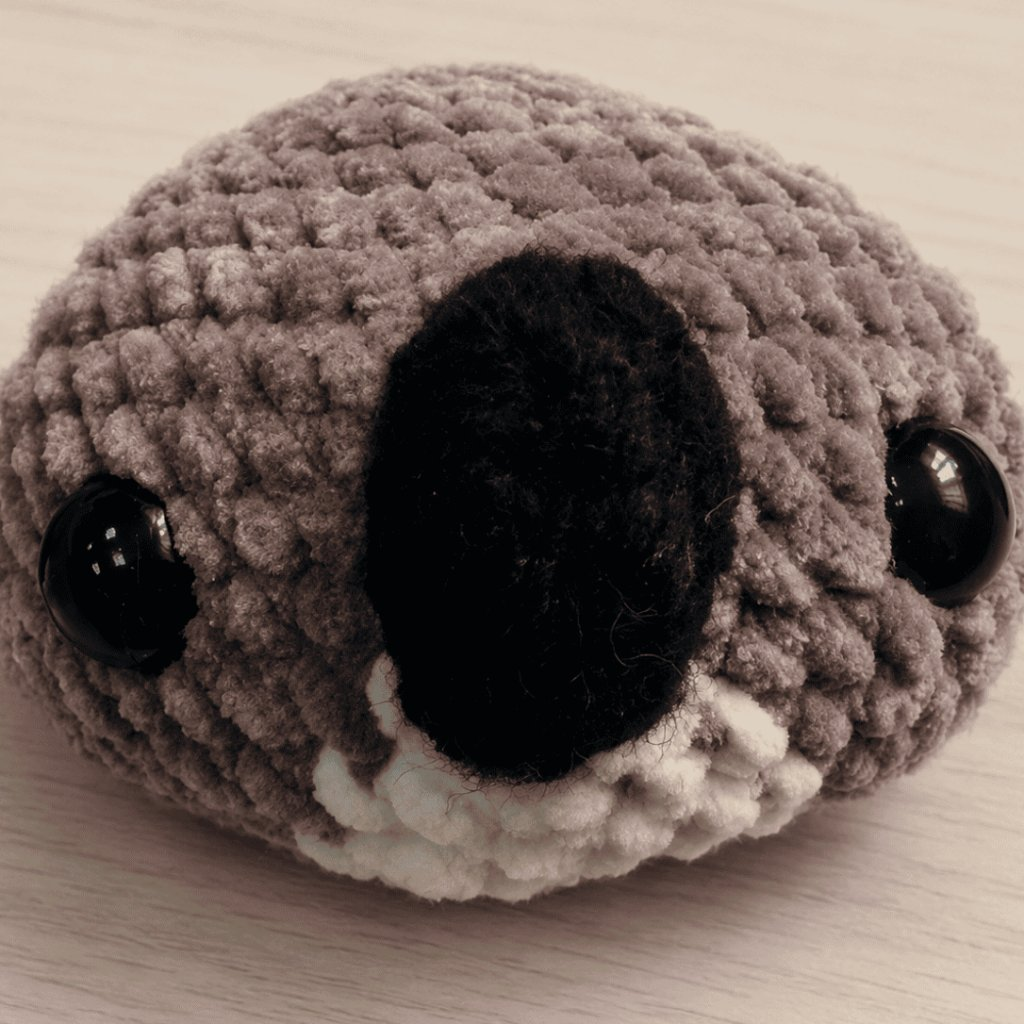 Crochet koala head with safety eyes and black nose
