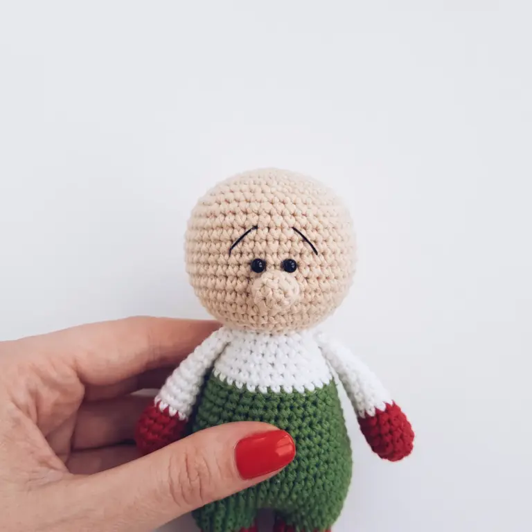 Close-up of the gnome's face with safety eyes, embroidered eyebrows, and nose attached