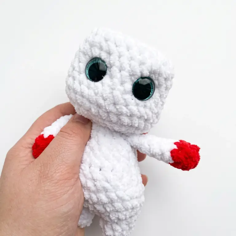 Close-up of the crocheted snowman head with sparkle safety eyes in place